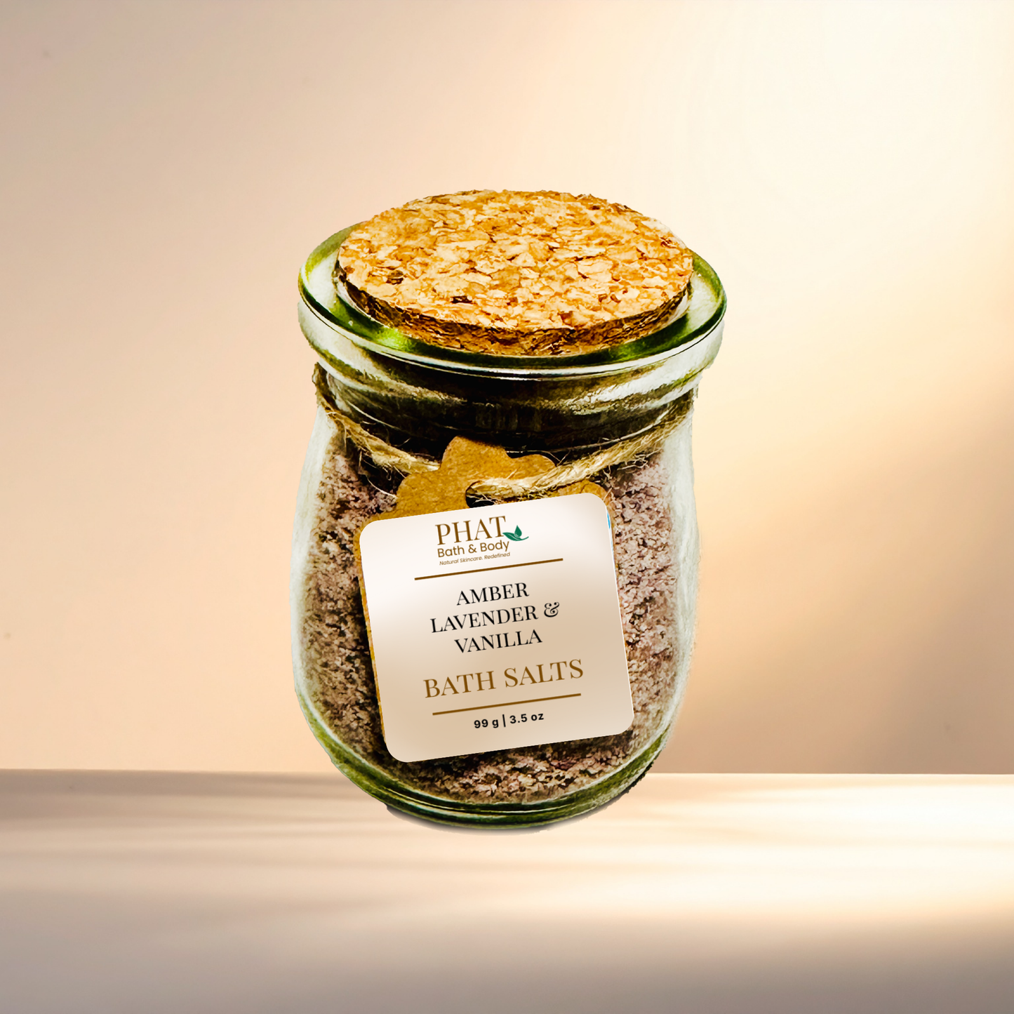 Jar of amber lavender vanilla bath salts with cork lid on a gradient background