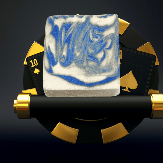 Decorative soap with blue and white design on a black and gold background