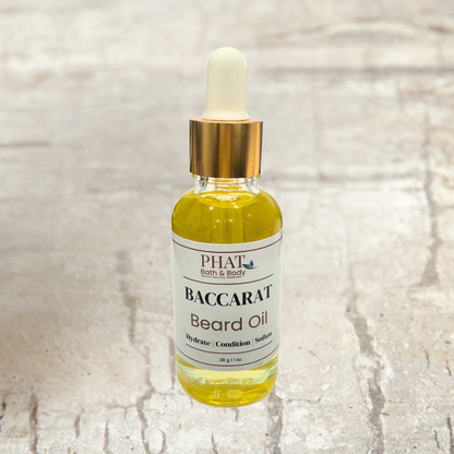 Bottle of PHAT Bath & Body Baccarat beard oil on a textured beige surface