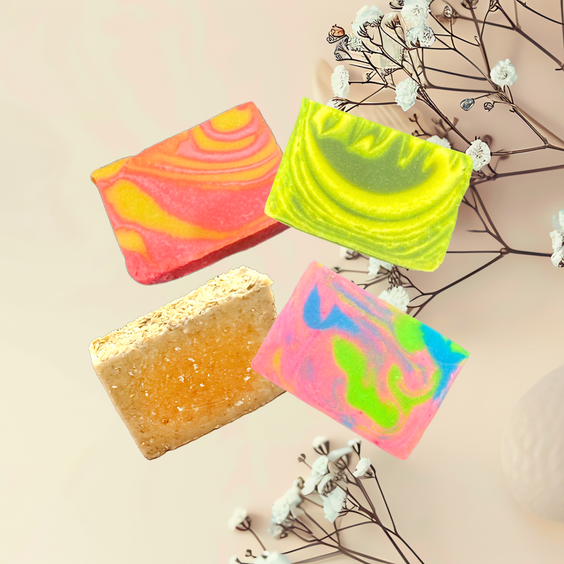 Four colorful soap bars on a light background with dried flowers.