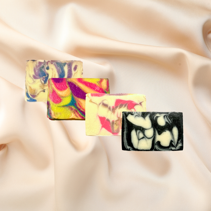 Three colorful soap bars on a satin background