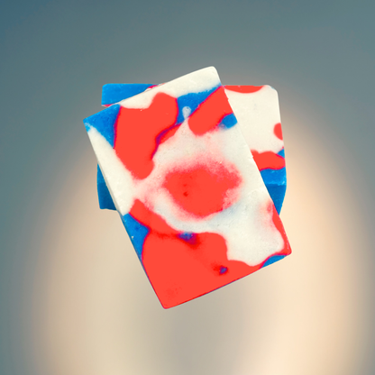 Colorful soap bar with red, white, and blue swirls on a gradient background