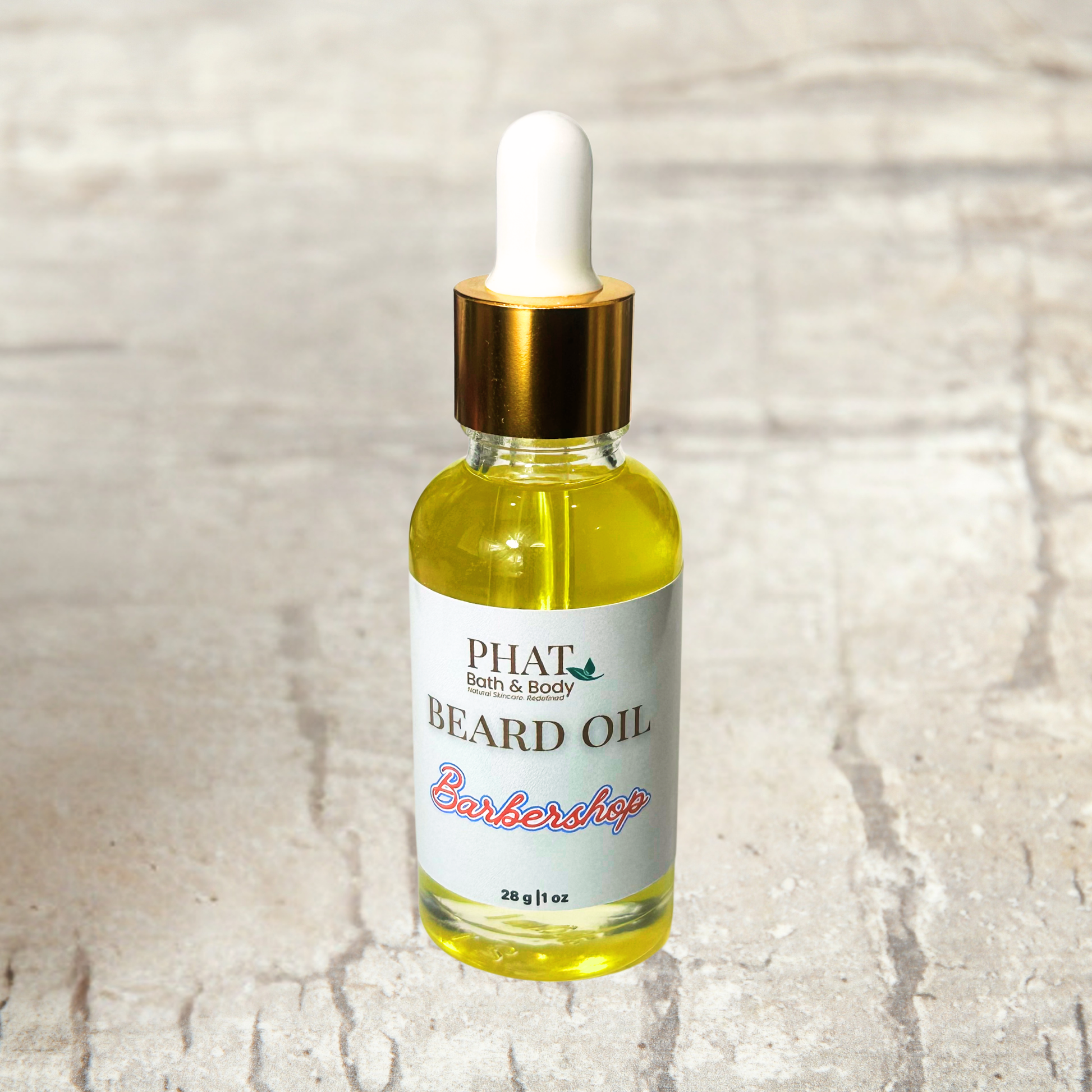 Bottle of Phat Bath & Body beard oil on a textured surface