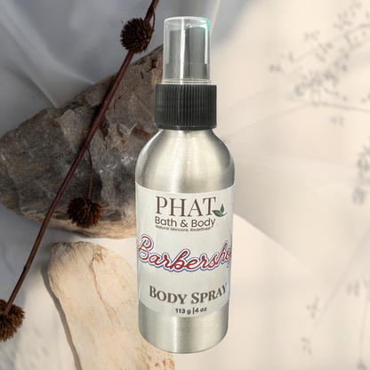Body spray bottle labeled 'PHAT Bath & Body' on a neutral background with decorative elements.