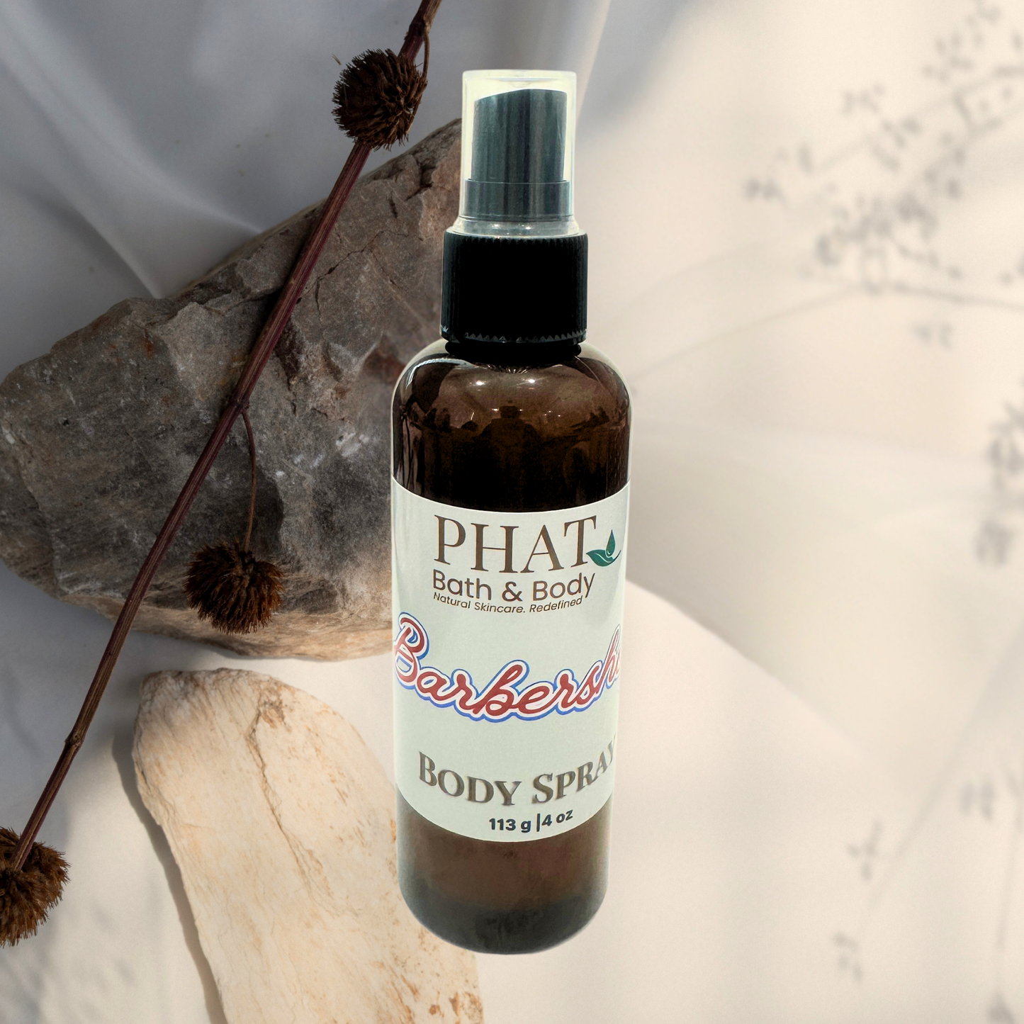 Body spray bottle with 'PHAT Bath & Body' label on a neutral background