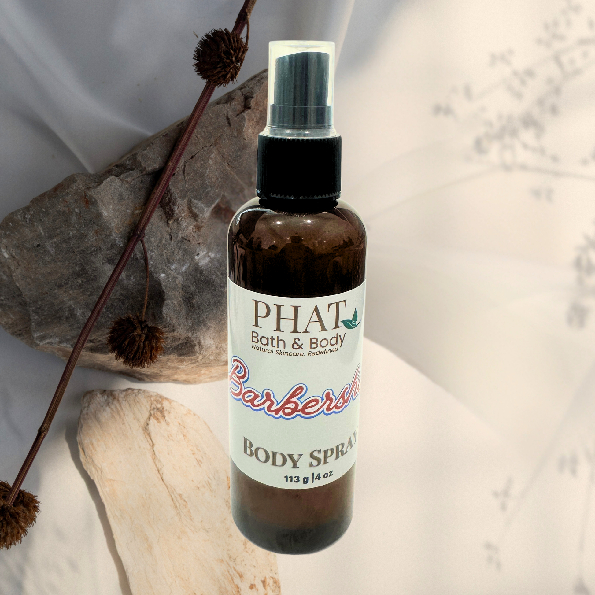 Body spray bottle with 'PHAT Bath & Body' label on a neutral background