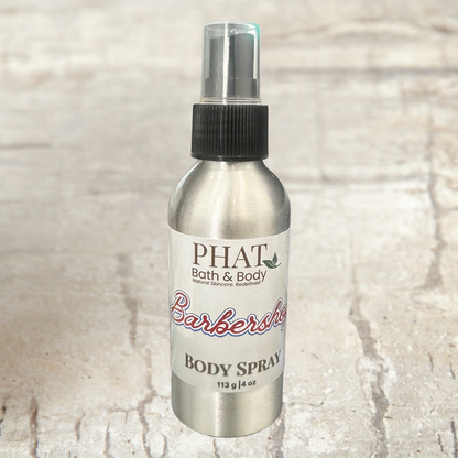 Body spray bottle labeled 'PHAT Bath & Body' on a textured beige background