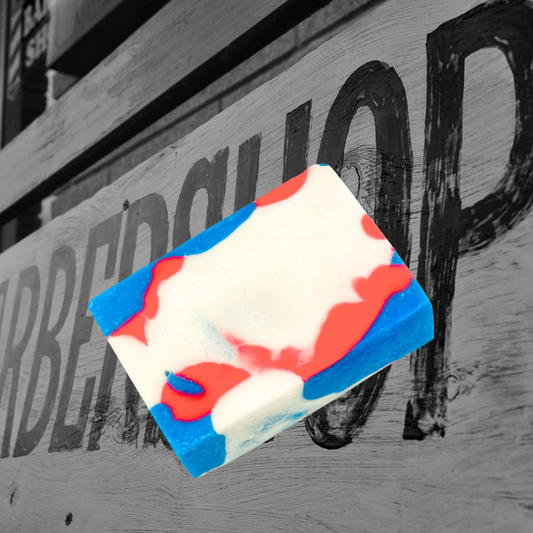 Colorful soap bar with red, white, and blue design on a blurred background