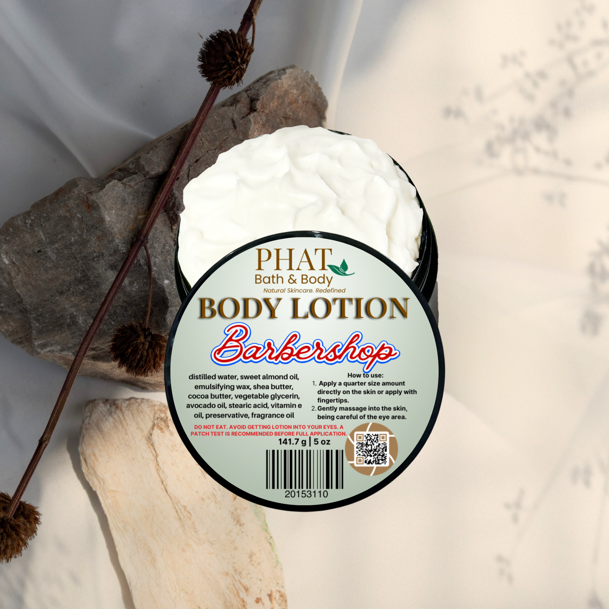 Body lotion container labeled 'Barbershop' by Phat Bath & Body on a natural stone background.