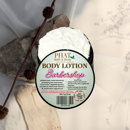 Body lotion container labeled 'Barbershop' by Phat Bath & Body on a natural stone background.