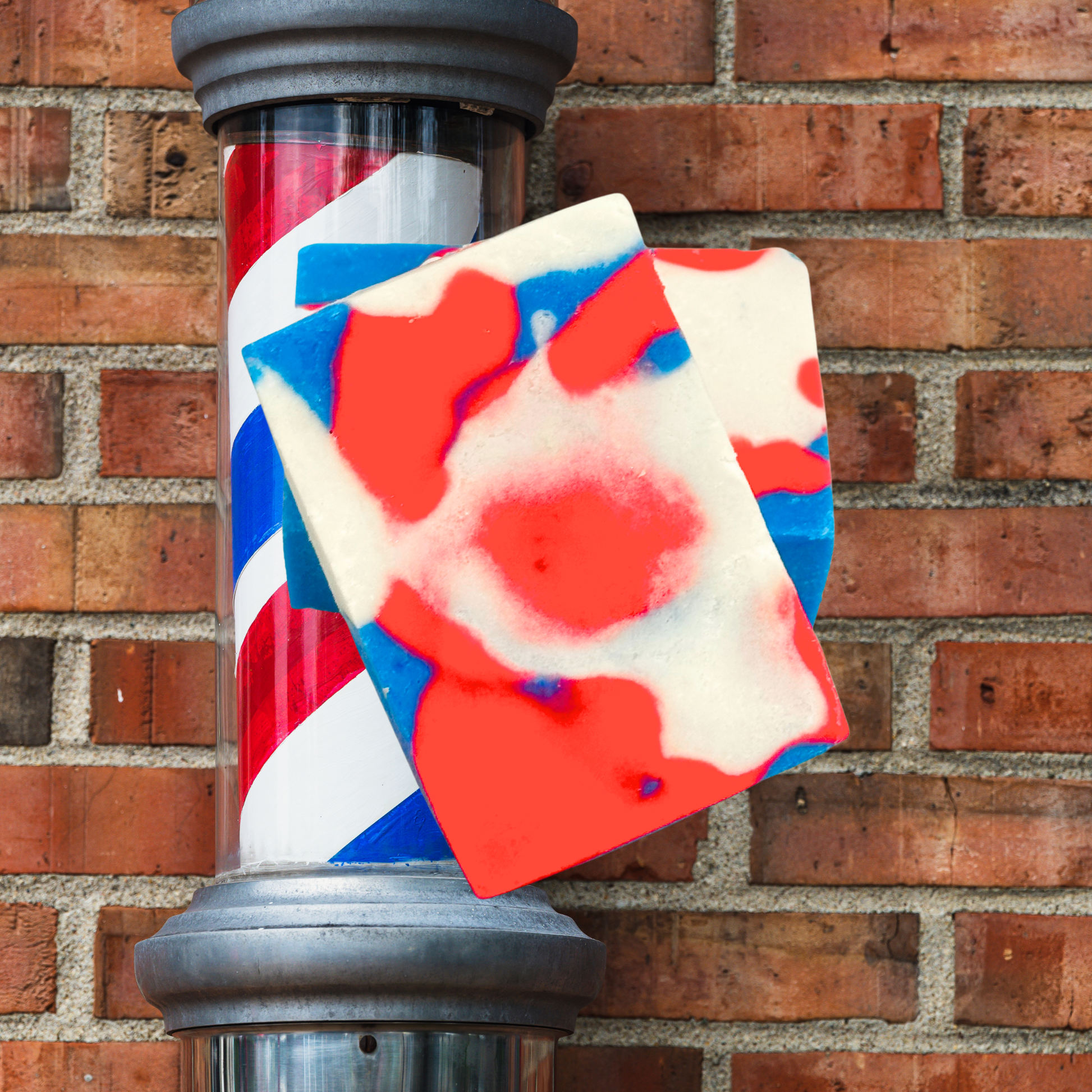 Colorful soap bar with geometric pattern leaning against a brick wall