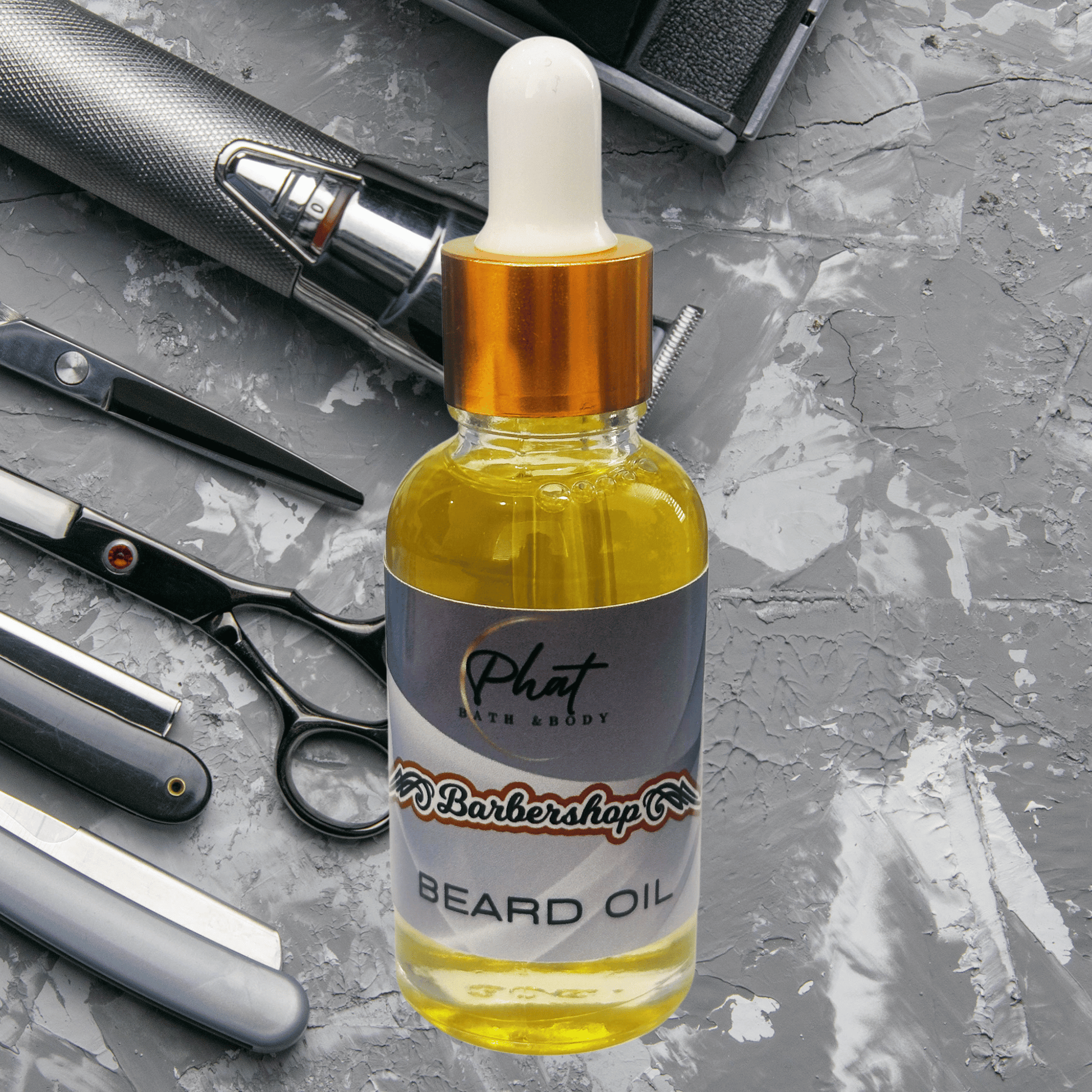 Bottle of Barbershop beard oil with barbershop tools on a gray surface