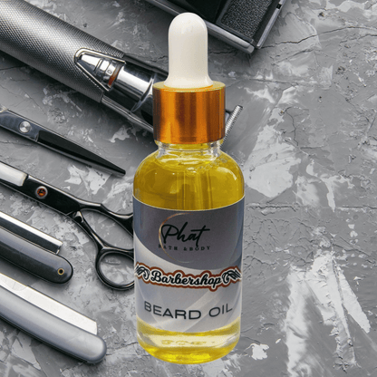 Bottle of Barbershop beard oil with barbershop tools on a gray surface