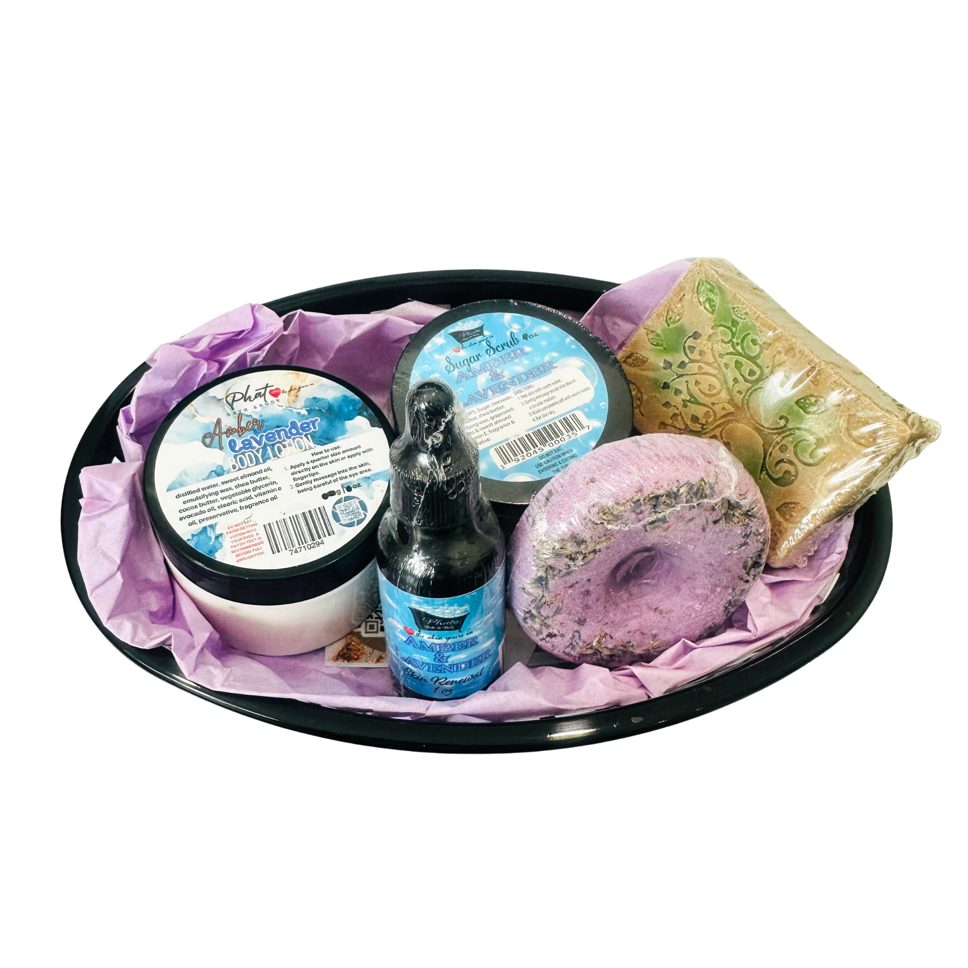 Bath and body set with a bottle, jar, and soap on a black tray with purple tissue paper.