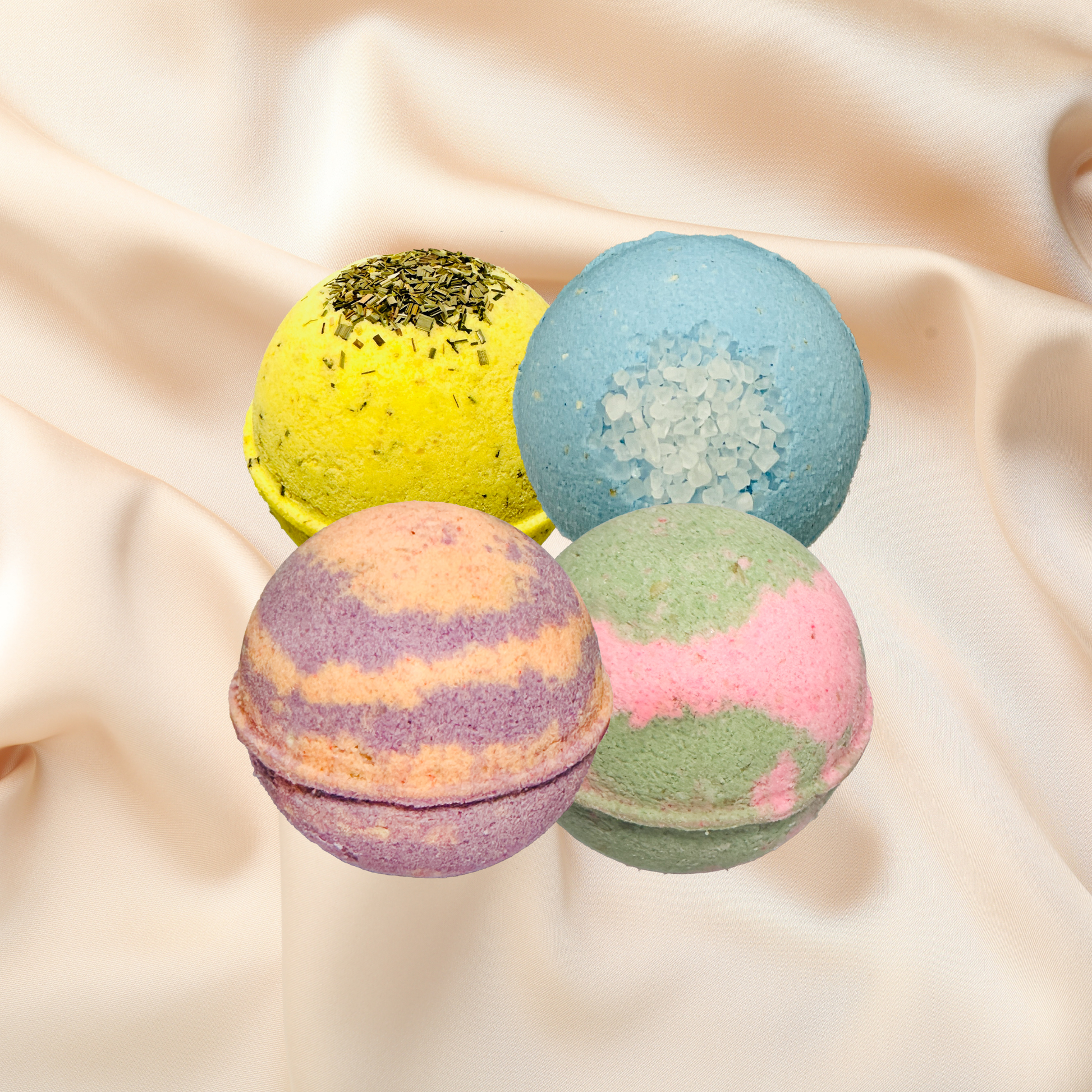 Four colorful bath bombs on a beige fabric background