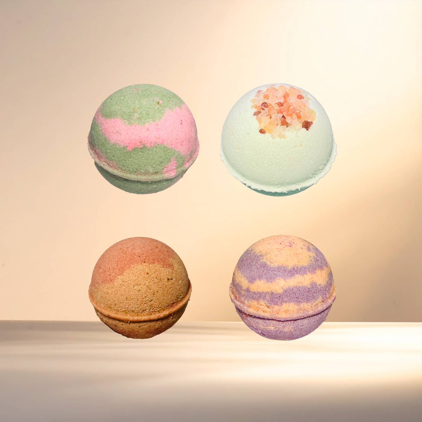 Four colorful bath bombs on a neutral background