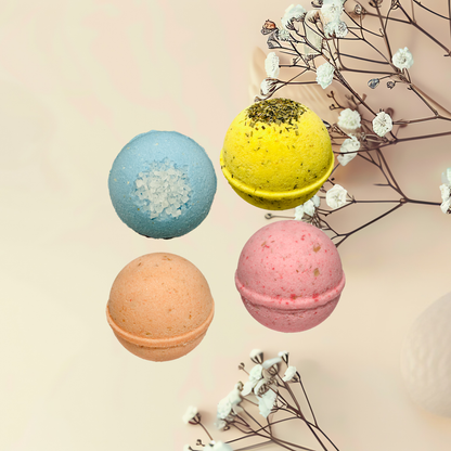 Four colorful bath bombs with decorative elements on a light background