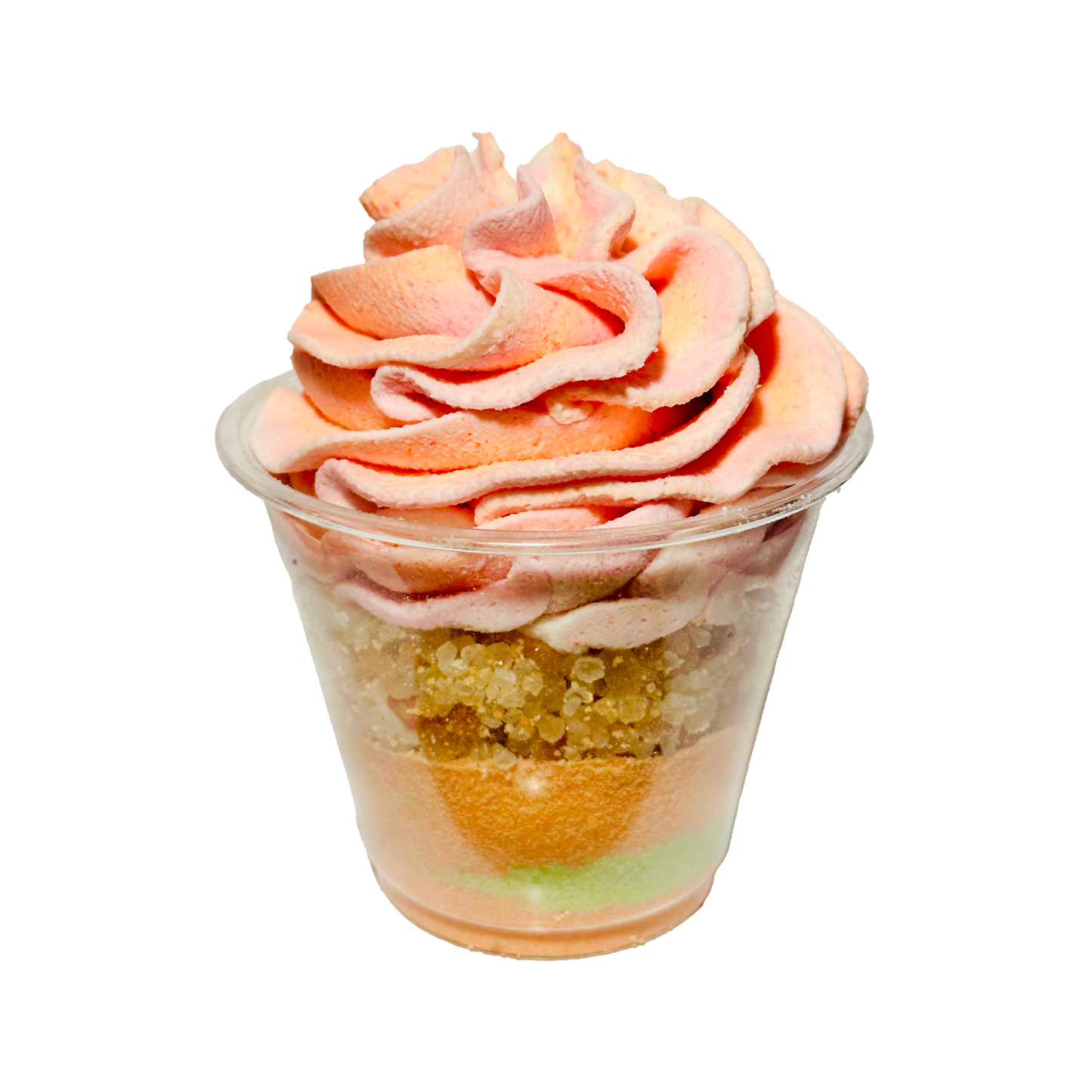 Bath parfait cup with pink and orange swirled topping on a white background