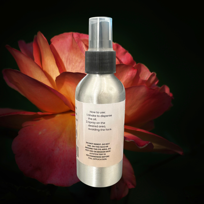 Spray bottle with label against a dark background with a red flower