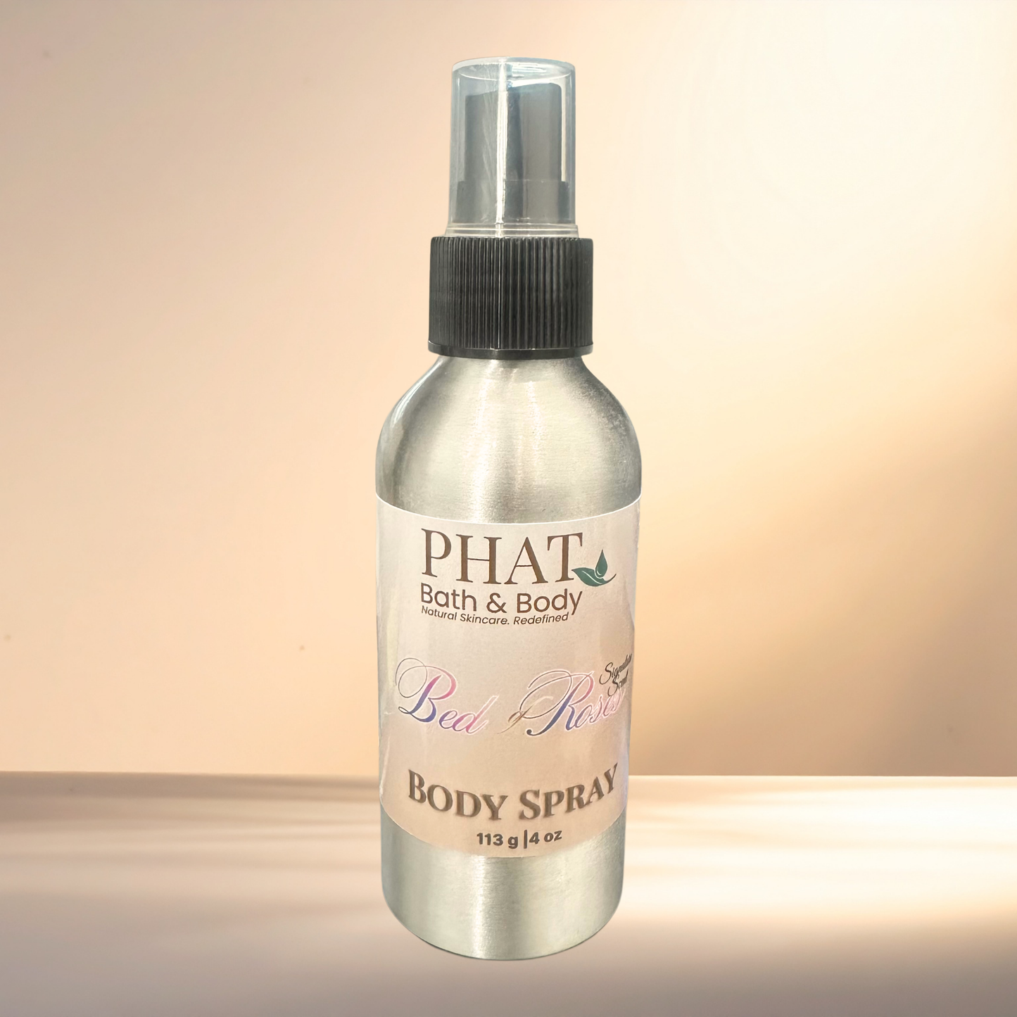 Body spray bottle labeled 'PHAT Bath & Body' on a gradient background