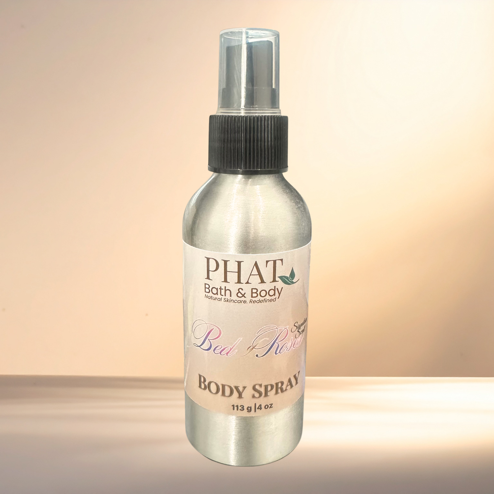 Body spray bottle labeled 'PHAT Bath & Body' on a gradient background