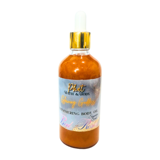 Bottle of shimmering body oil with a gold cap on a white background