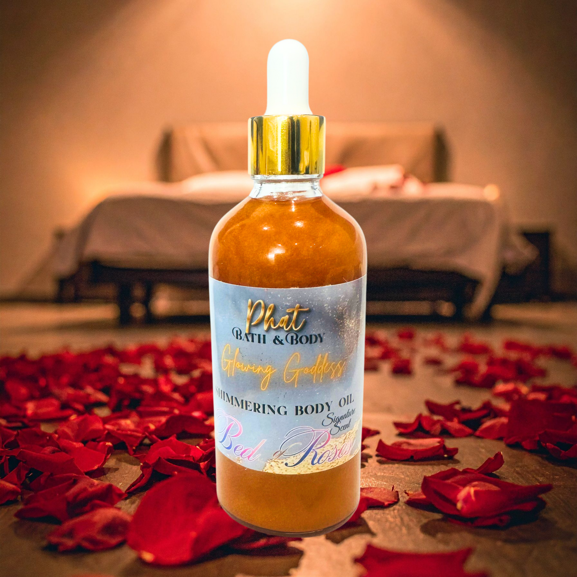 Bottle of 'Phat Bath & Body' shimmering body oil with rose petals on a bed.