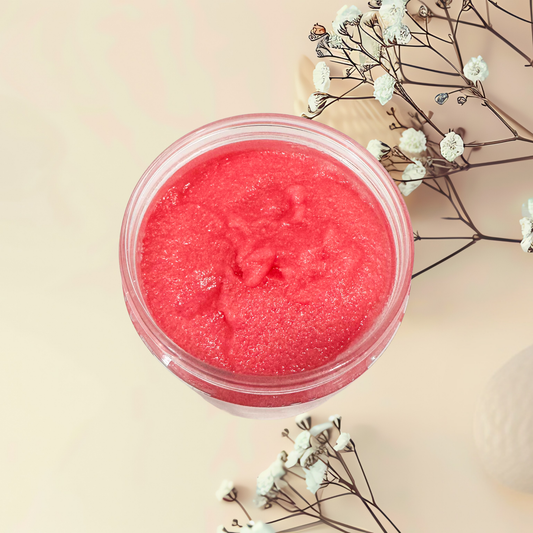 Pink scrub in a jar with white flowers on a beige background