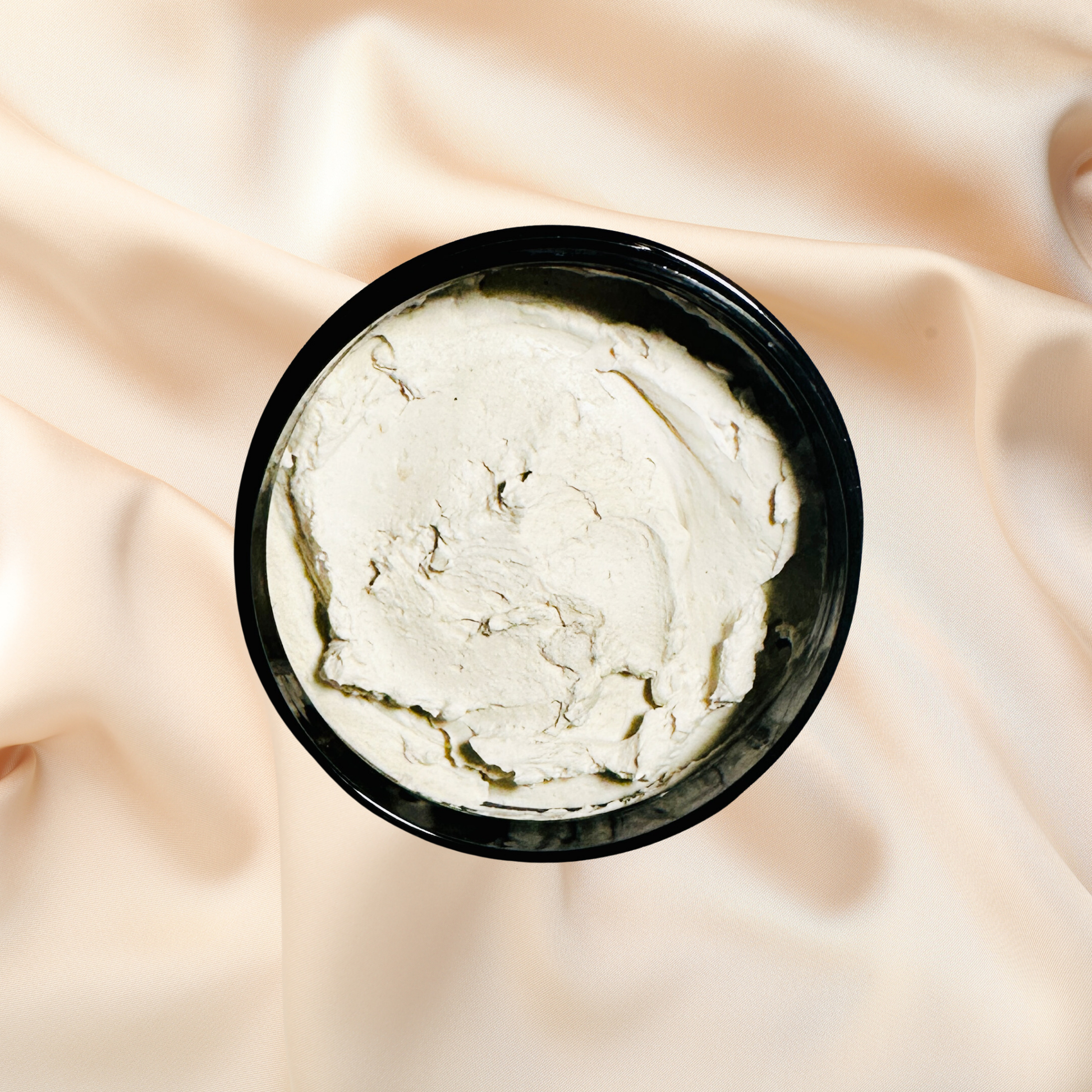 Black container of white mask on a beige fabric background
