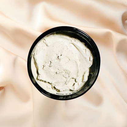 Black container of white mask on a beige fabric background
