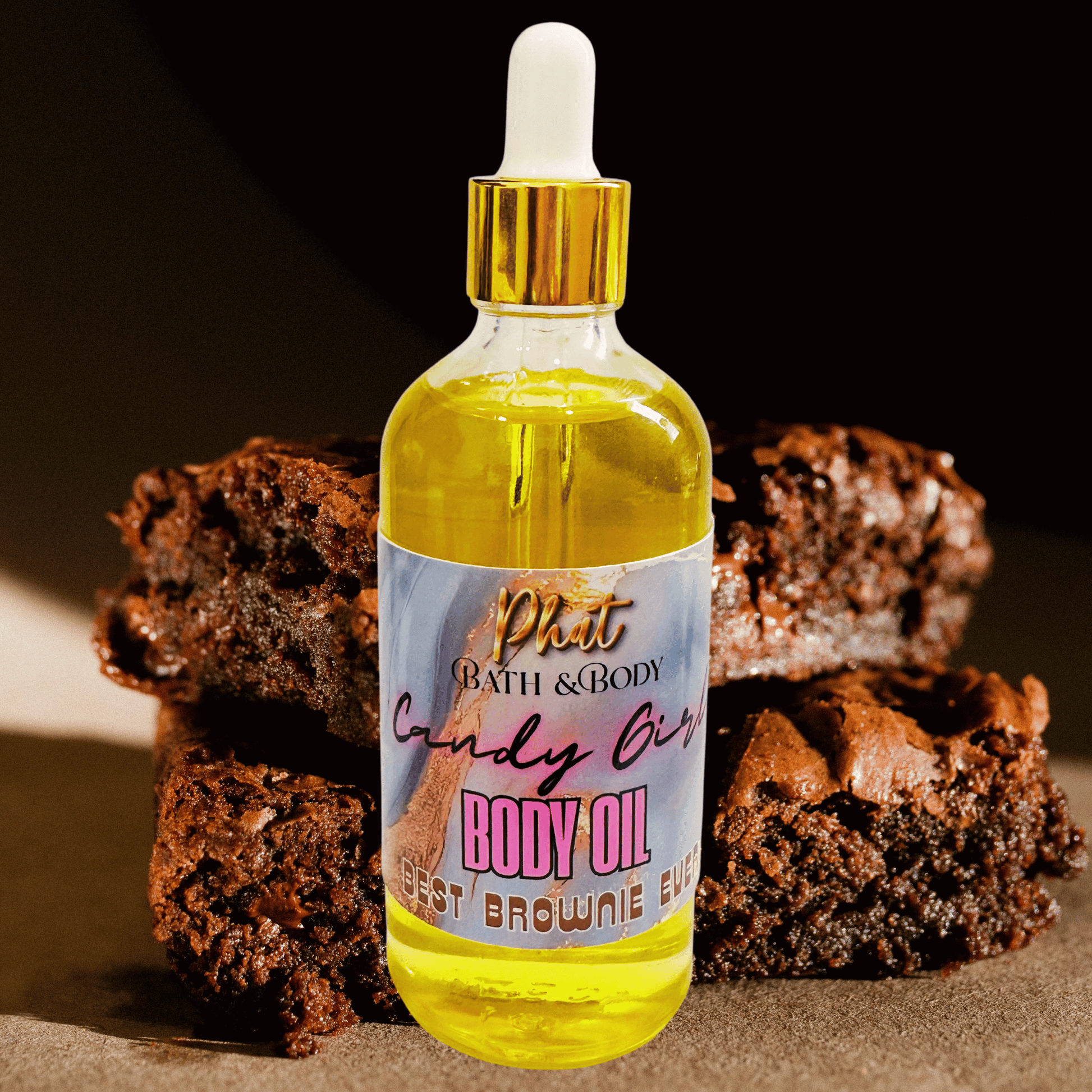Bottle of body oil with a brownie-themed label in front of brownies