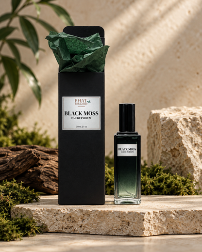 Black Moss men’s Eau de Parfum bottle with black gift box and green tissue in a luxury setting.