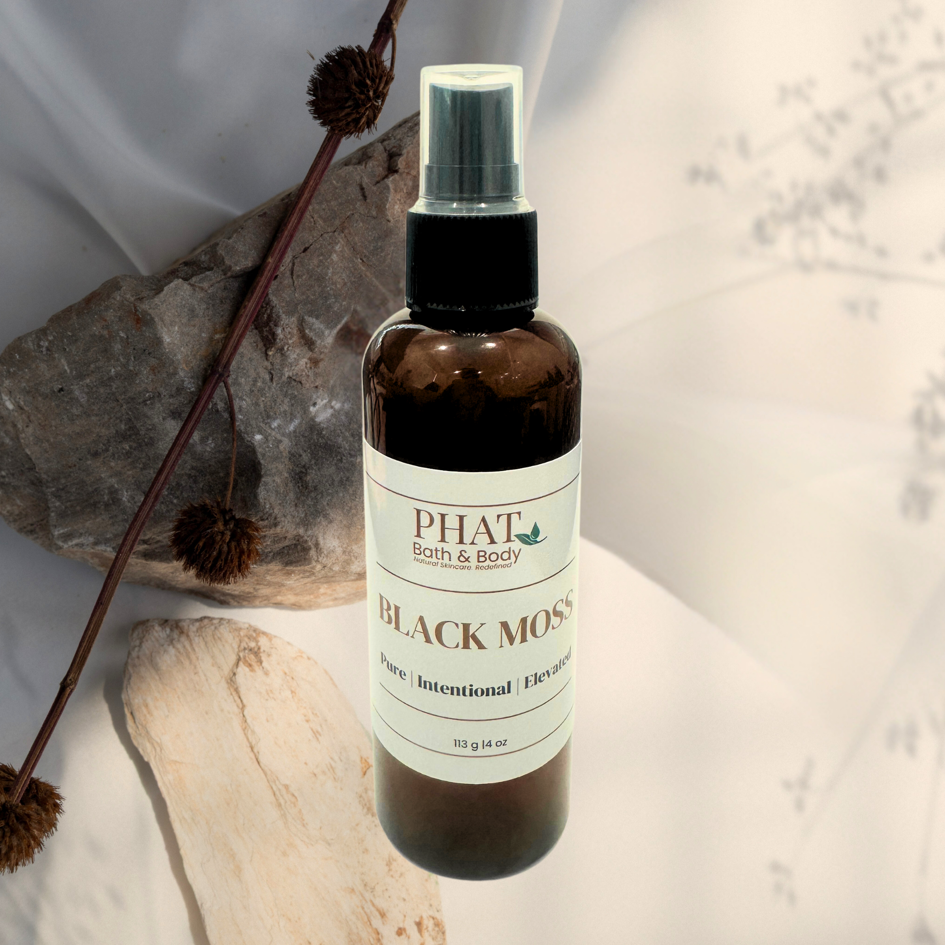 Bottle of 'Black Moss' by Phat Bath & Body on a neutral background