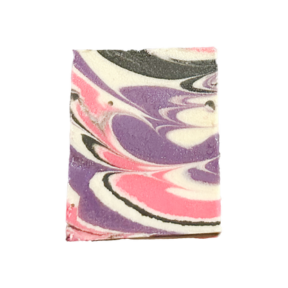 Marbled soap bar with purple, pink, and white swirls on a white background