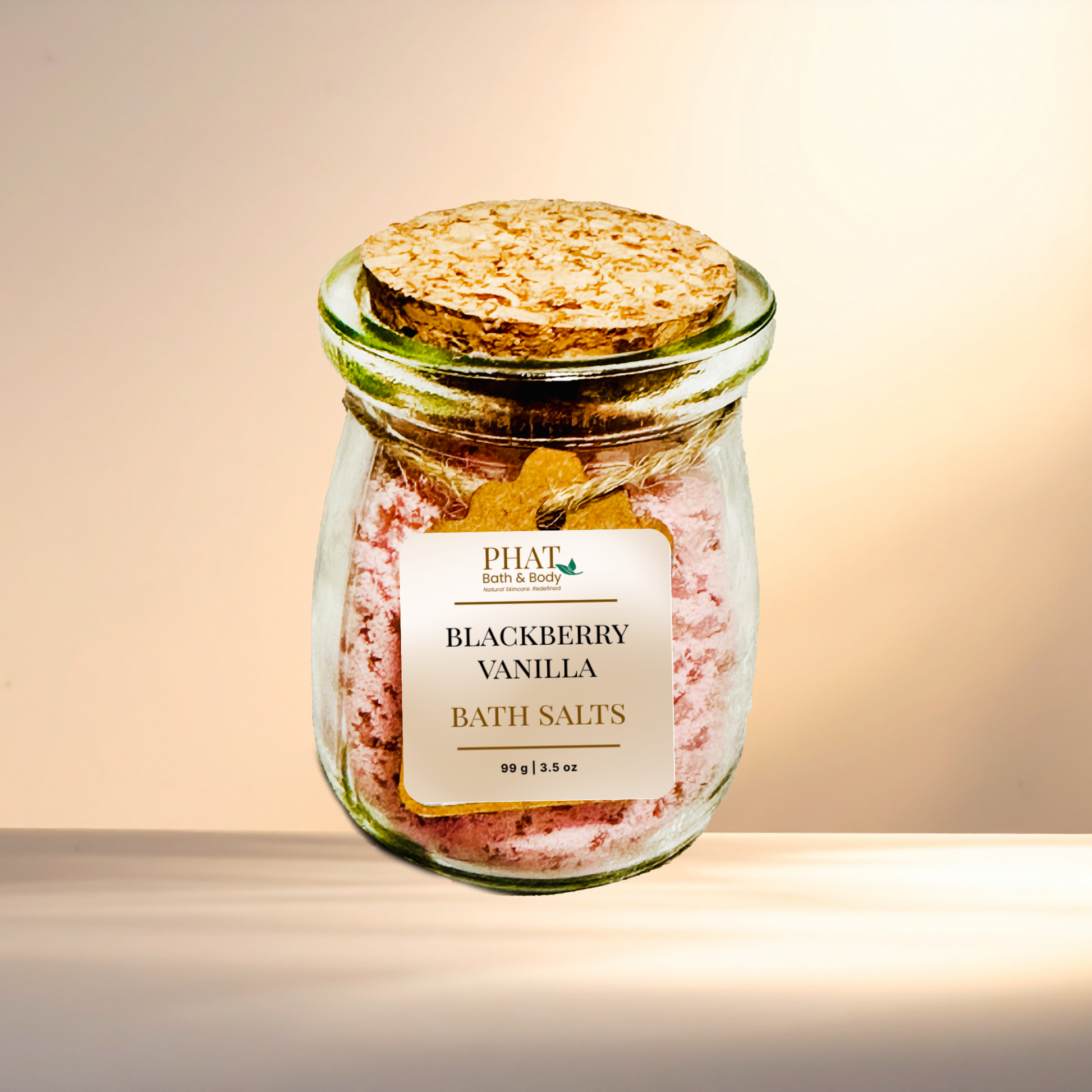 Jar of blackberry vanilla bath salts with a cork lid on a gradient background