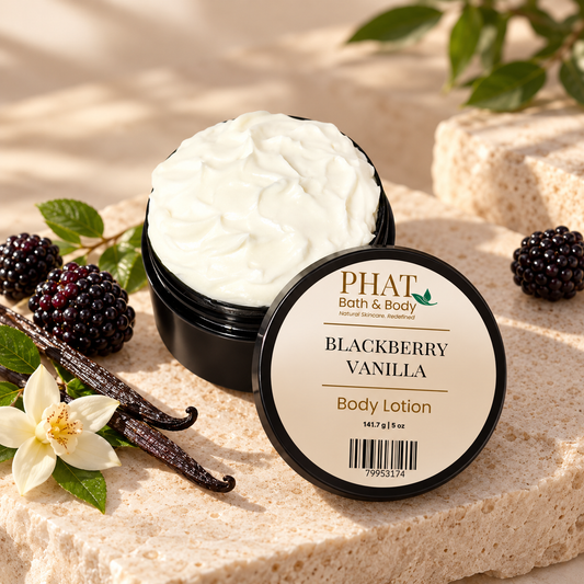 Phat Bath & Body Blackberry Vanilla 5 oz Body Lotion in an open black jar with labeled lid, styled with blackberries, vanilla beans, vanilla flower, and warm natural stone.