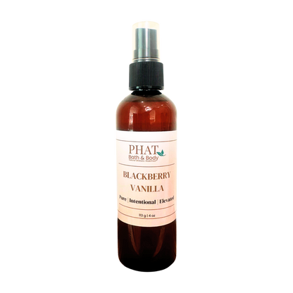 An amber spray bottle of PHAT Bath & Body Blackberry Vanilla perfume, featuring a cream-colored label and a black spray nozzle, set against a plain white background.