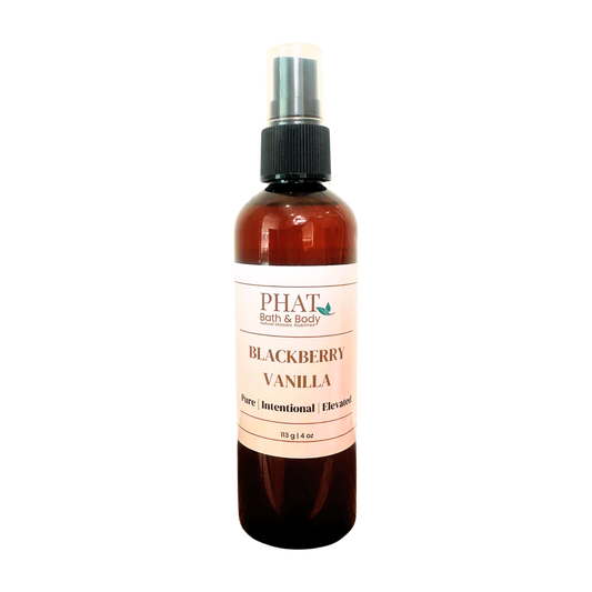 An amber spray bottle of PHAT Bath & Body Blackberry Vanilla perfume, featuring a cream-colored label and a black spray nozzle, set against a plain white background.