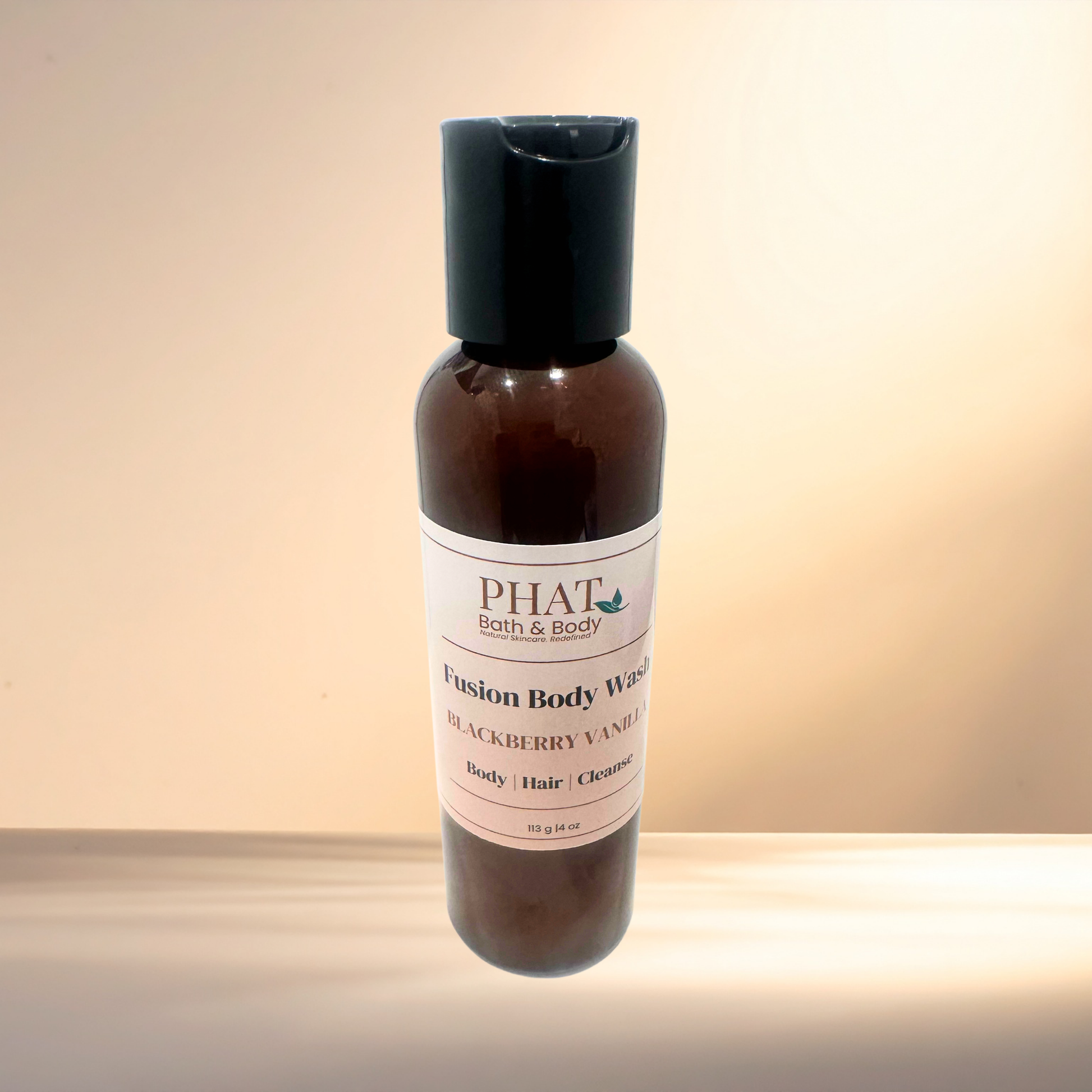 Fusion Body Wash bottle with 'PHAT Bath & Body' label on a gradient background