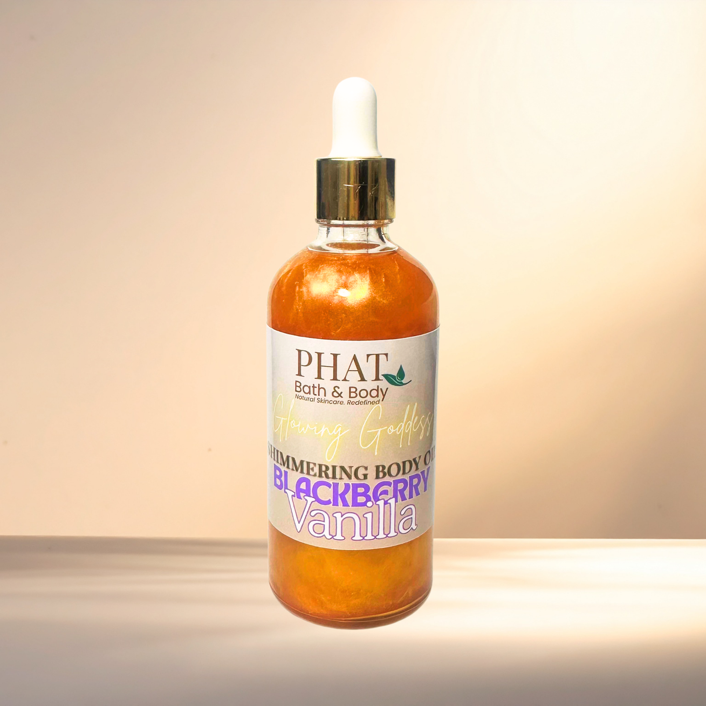Bottle of 'PHAT Bath & Body' blackberry vanilla body oil on a gradient background