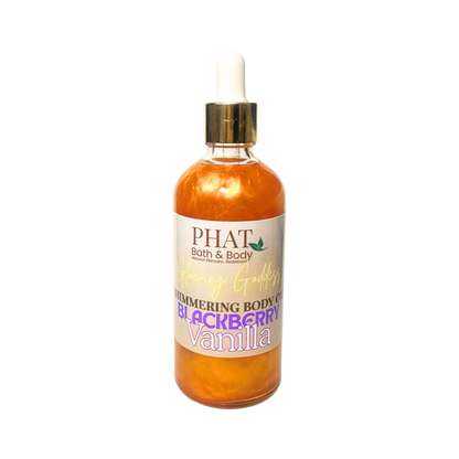 Bottle of 'Glowing Goddess' shimmering body oil by Phat Bath & Body on a white background