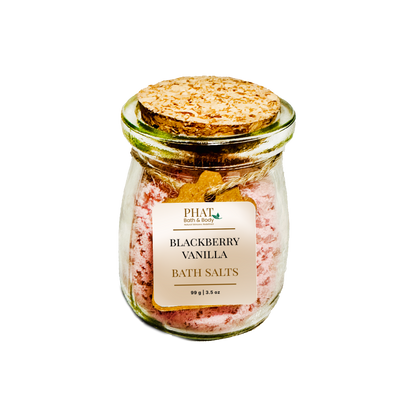 Jar of blackberry vanilla bath salts with a cork lid on a white background