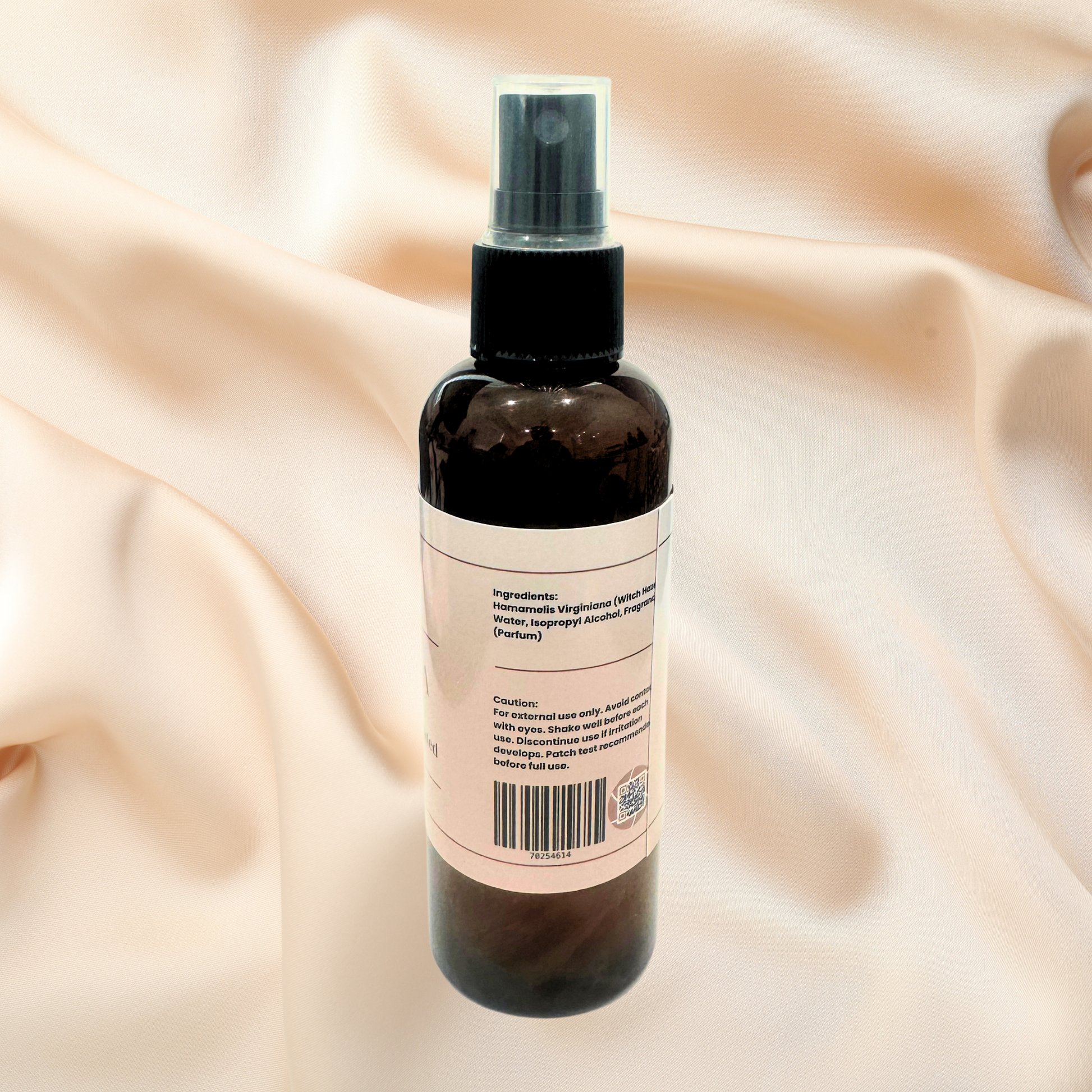 Bottle with a label on a beige fabric background