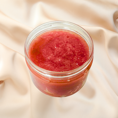 Jar of red scrub on a beige fabric background