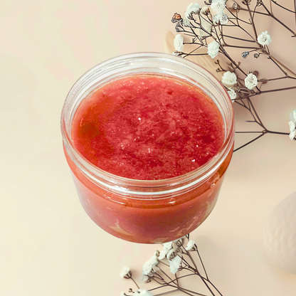 Jar of red scrub on a light beige background with white flowers