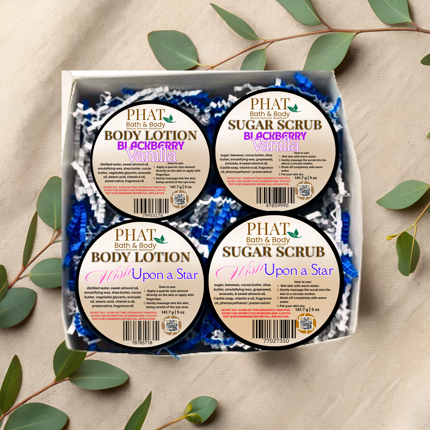 Box of Phat Bath & Body products including body lotion and sugar scrub with green leaves around.