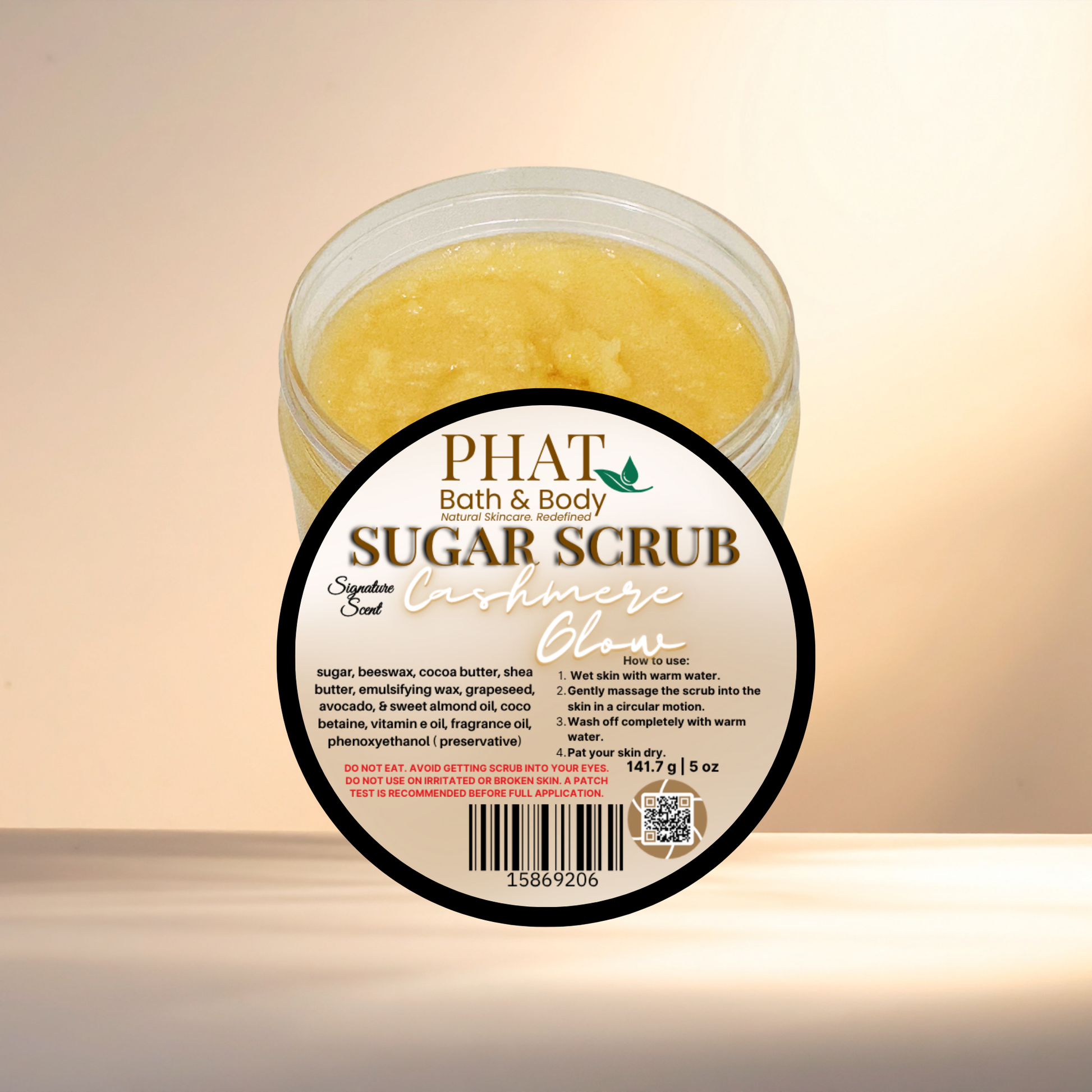 Jar of sugar scrub with a visible label on a light background