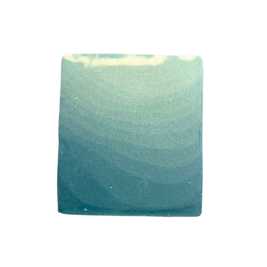 Greenish-blue square soap on a white background