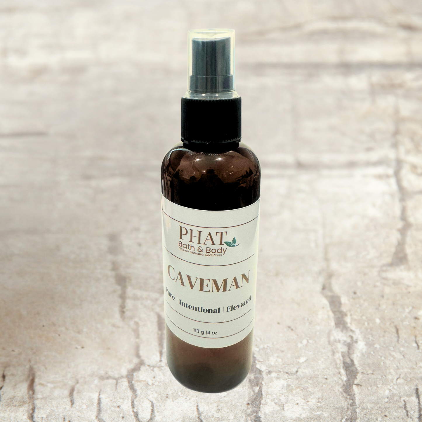 Bottle of 'Caveman' product from Phat Bath & Body on a textured beige background