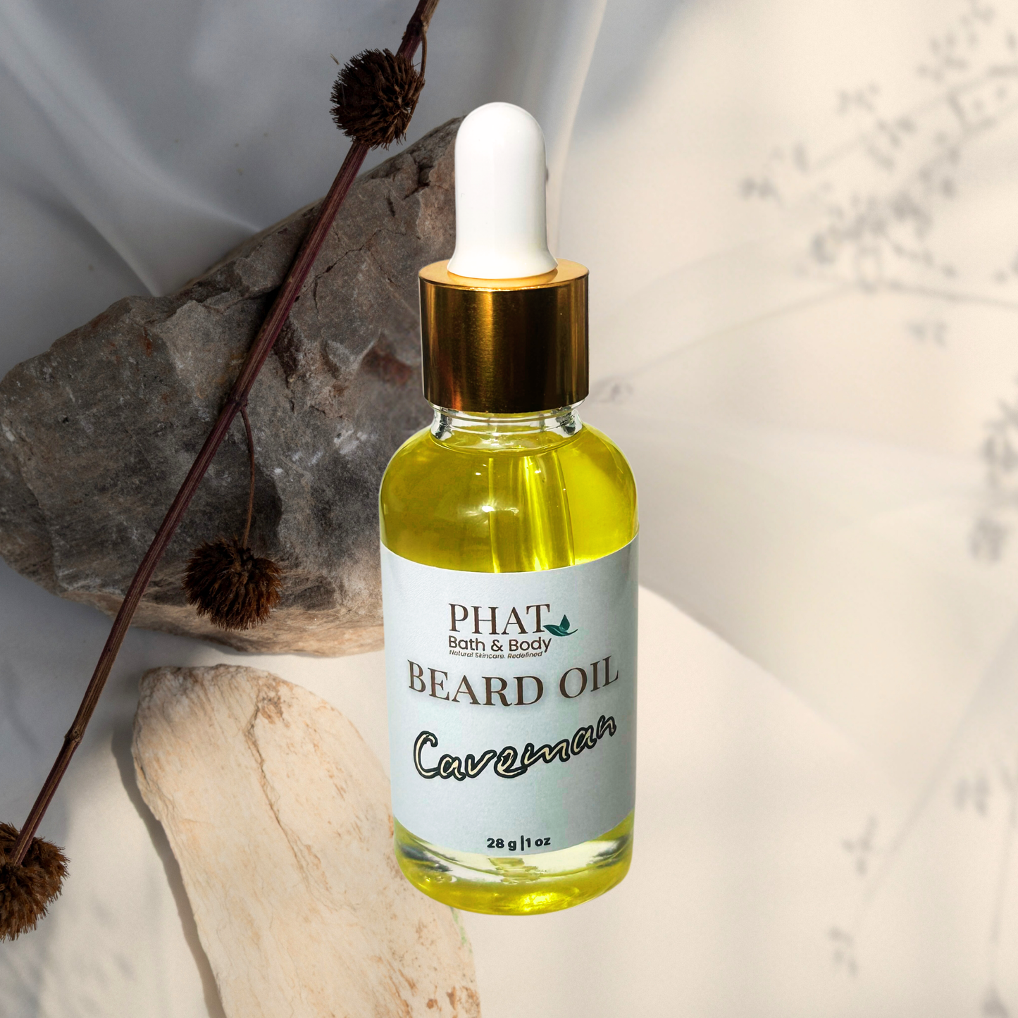 Bottle of Phat Bath & Body beard oil with a dropper on a neutral background